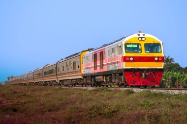 Passenger train by diesel locomotive on the railway.