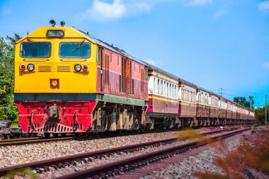 Passenger train by diesel locomotive on the railway.