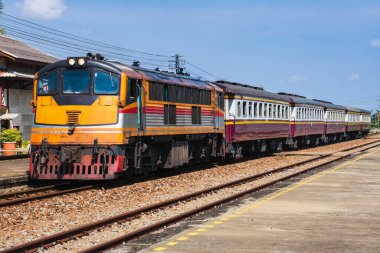 Passenger train by diesel locomotive on the railway.