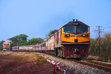 Passenger train by diesel locomotive on the railway.