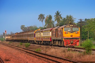 Passenger train by diesel locomotive on the railway.