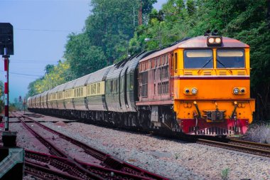 Passenger train by diesel locomotive on the railway.