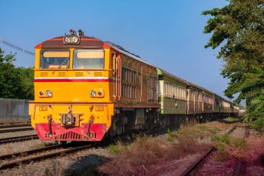 Passenger train by diesel locomotive on the railway.