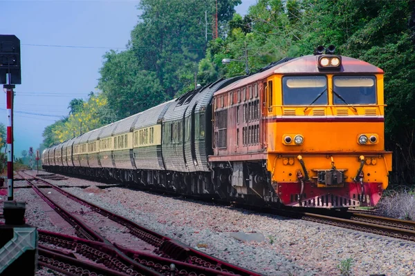 Passenger train by diesel locomotive on the railway.