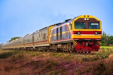 Passenger train by diesel locomotive on the railway.