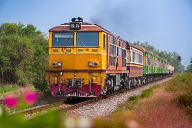 Passenger train by diesel locomotive on the railway.