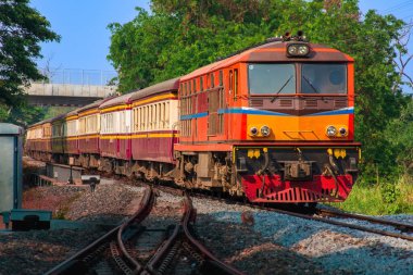 Passenger train by diesel locomotive on the railway.