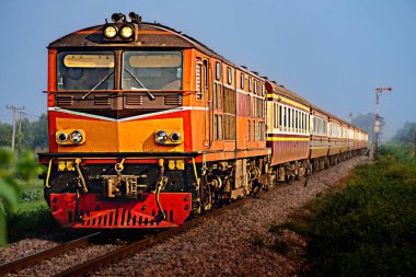 Passenger train by diesel locomotive on the railway.