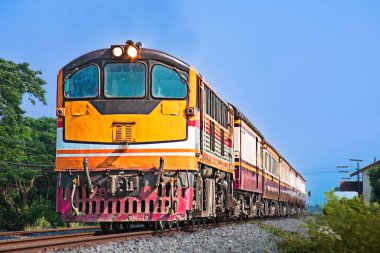 Passenger train by diesel locomotive on the railway.