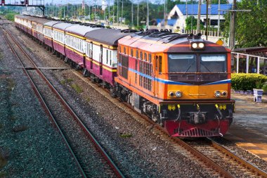 Passenger train by diesel locomotive on the railway.