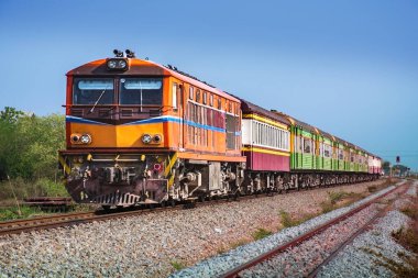 Passenger train by diesel locomotive on the railway.