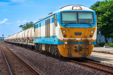 Tanker-freight train by diesel locomotive on the railway.