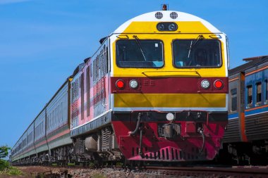 Passenger train by diesel locomotive on the railway.