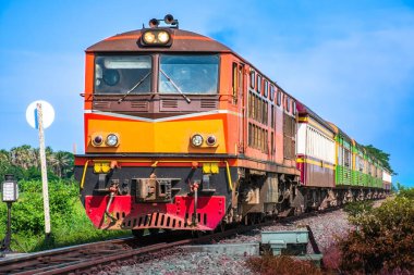 Passenger train by diesel locomotive on the railway.
