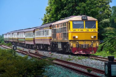 Passenger train by diesel locomotive on the railway.