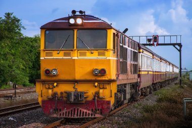 Passenger train by diesel locomotive on the railway.