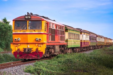 Passenger train by diesel locomotive on the railway.