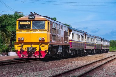 Passenger train by diesel locomotive on the railway.