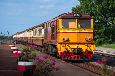 Passenger train by diesel locomotive on the railway.