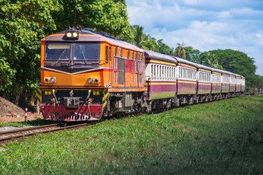 Passenger train by diesel locomotive on the railway.