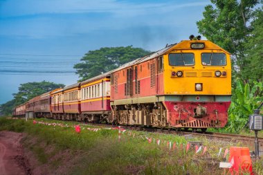 Passenger train by diesel locomotive on the railway.
