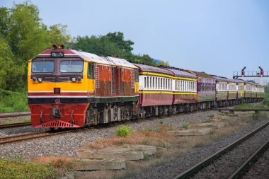 Passenger train by diesel locomotive on the railway.