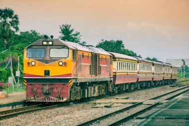Passenger train by diesel locomotive on the railway.
