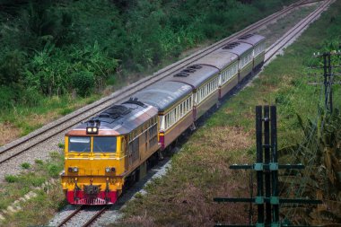 Passenger train by diesel locomotive on the railway.