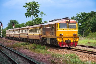 Passenger train by diesel locomotive on the railway.