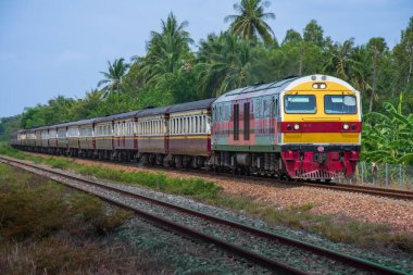 Passenger train by diesel locomotive on the railway.