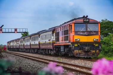 Passenger train by diesel locomotive on the railway.