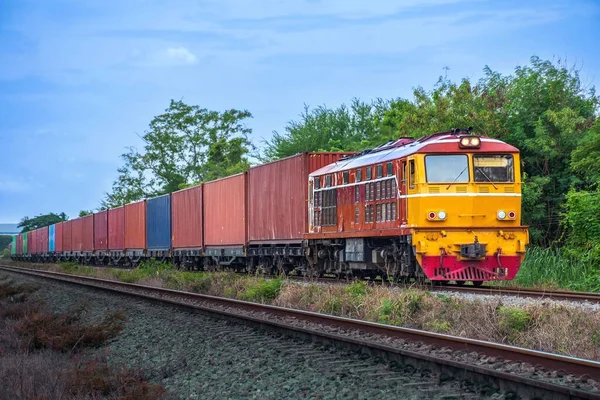 stock image Container-freight train by diesel locomotive on the railway.