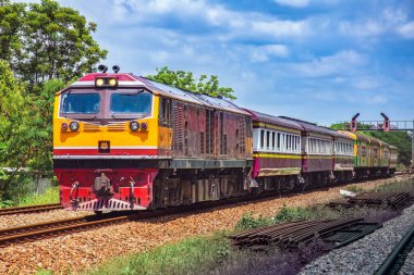 Passenger train by diesel locomotive on the railway.