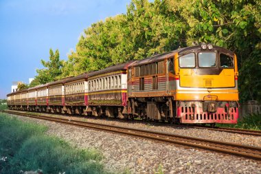 Passenger train by diesel locomotive on the railway.