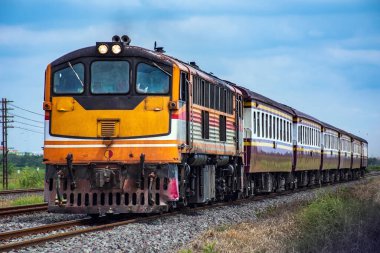 Passenger train by diesel locomotive on the railway.