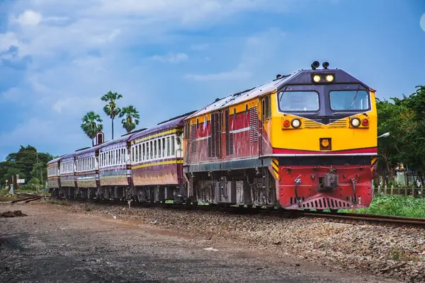 Passenger train by diesel locomotive on the railway.