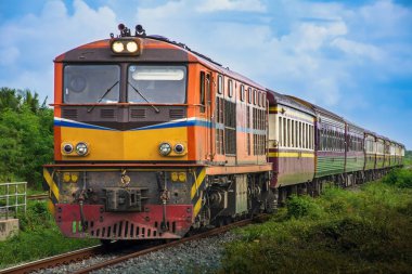 Passenger train by diesel locomotive on the railway.