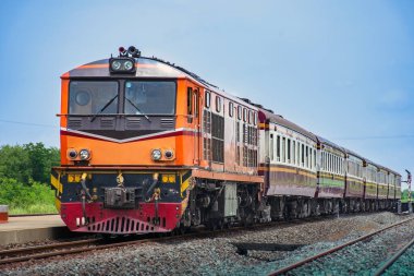 Passenger train by diesel locomotive on the railway.