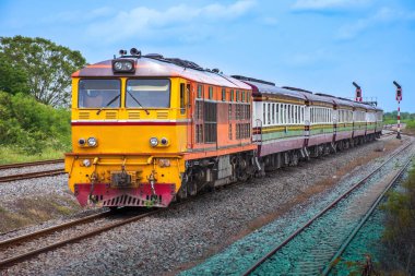 Passenger train by diesel locomotive on the railway.