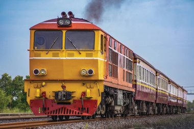 Passenger train by diesel locomotive on the railway.