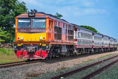 Passenger train by diesel locomotive on the railway.