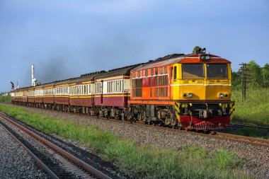 Passenger train by diesel locomotive on the railway.