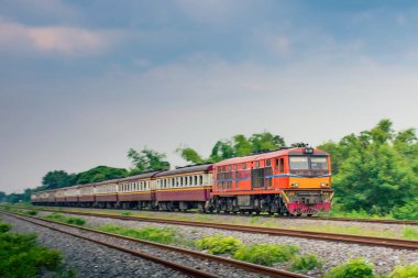 Passenger train by diesel locomotive on the railway.