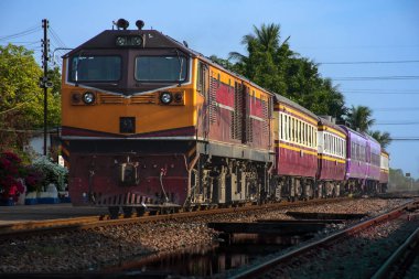 Passenger train by diesel locomotive on the railway.