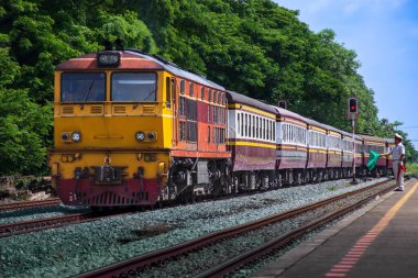Passenger train by diesel locomotive on the railway.