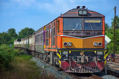 Passenger train by diesel locomotive on the railway.