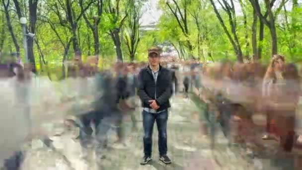 Человек Стоял Один Размытой Толпы Фоне Зеленых Деревьев Камера Приближается — стоковое видео