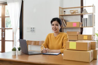 Başlangıçta küçük işletme girişimcisi online KOBİ ya da ev konseptinde çalışan serbest çalışan kadın, yurtiçi ofiste genç Asyalı küçük işletme sahibi, çevrimiçi pazarlama paketleme ve dağıtım, KOBİ kavramı.