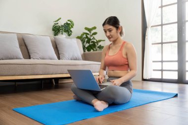 Young woman Exercising At Laptop Having Online Training At Home.