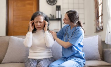 Female nurse visit old grandmother patient at home listen to complains concerns, attentive young woman doctor consulting mature senior grandma, elderly medical healthcare concept.